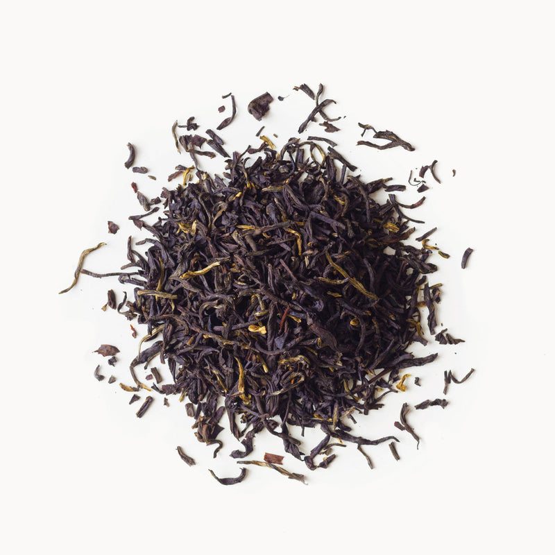 A pile of Earl Grey Supreme tea from Rishi Tea & Botanicals on a white background.