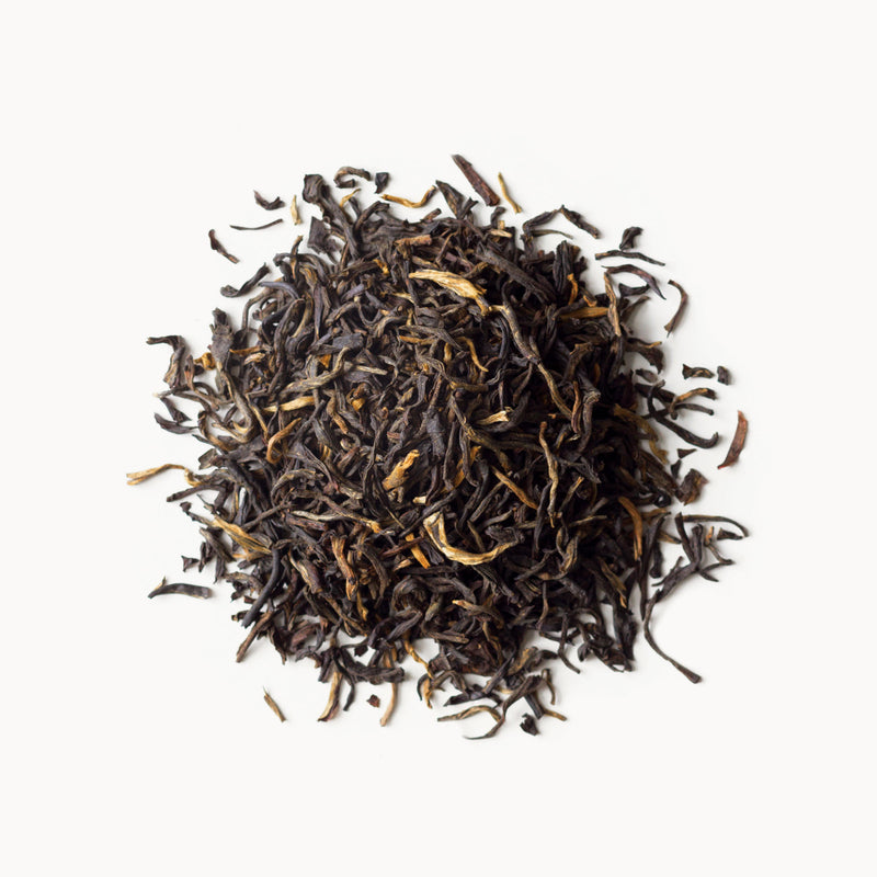 A pile of Golden Yunnan black tea on a white background from Rishi Tea & Botanicals.
